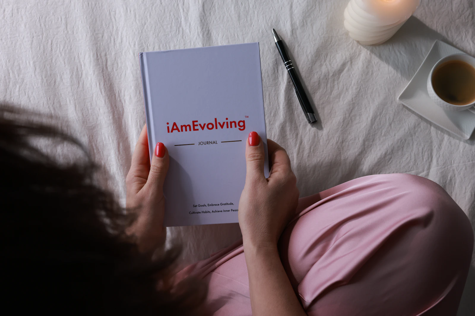 A person pauses to write in a journal, illustrating private reflection.